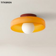 an orange and white light hanging from the ceiling