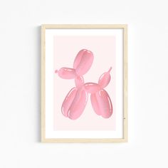 an art print with pink balloons floating in the air on a light pink wall above a wooden frame