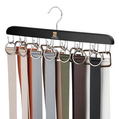 an assortment of belts hanging on a metal rail with hooks and clips attached to them