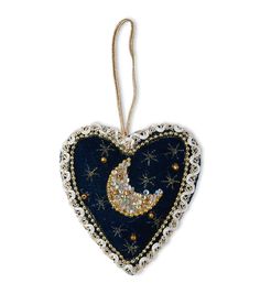 an ornament in the shape of a heart with a crescent and stars on it