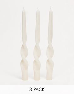 three white candles sitting next to each other with the words 3 pack in front of them