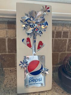 a pepsi bottle opener is decorated with snowflakes and metal flowers in the shape of a flower