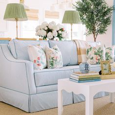 a living room filled with furniture and flowers