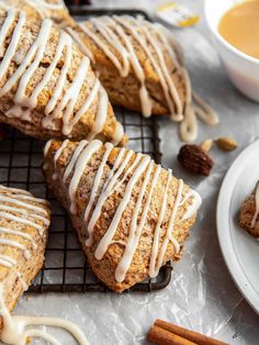 cinnamon roll with icing sitting on top of a cooling rack