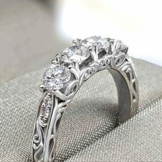 an engagement ring with three diamonds on it