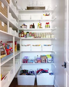 an organized pantry with white shelves and bins