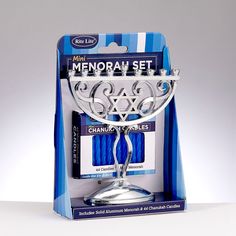 the menorah set is packaged in a blue box with silver accents and an elegant design