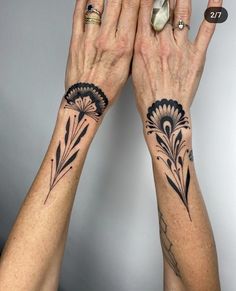 two women with matching tattoos on their hands