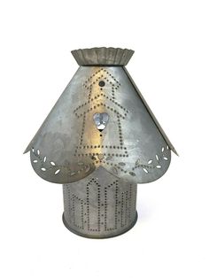 a metal candle holder with a dog on it's face in the shape of a lamp