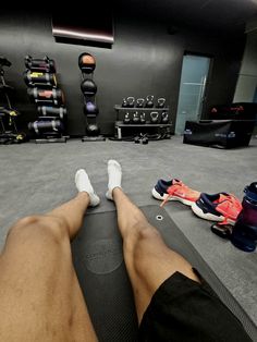 a person laying on a mat in a gym