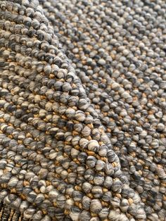 a close up view of a rug with small balls on it