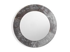 a round mirror sitting on top of a white wall