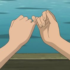 two hands reaching for each other in front of water