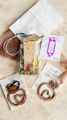 some crafting supplies are laying out on the floor next to an envelope and other items