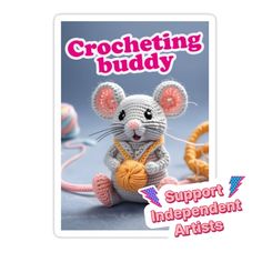 a crocheted mouse holding a ball of yarn