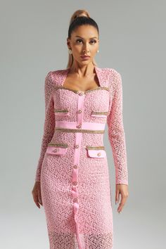 a woman wearing a pink dress and jacket