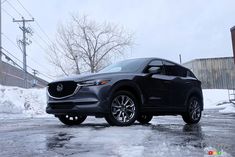 a gray mazda cx - 5 parked in the snow