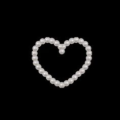 a heart made out of pearls on a black background