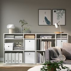 a living room filled with furniture and bookshelves next to a white coffee table