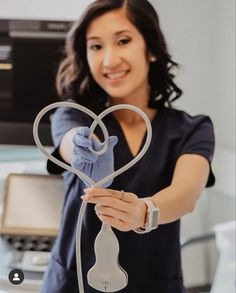 a woman holding up a heart shaped device