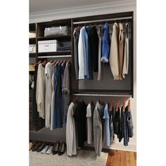 an organized closet with clothes and shoes