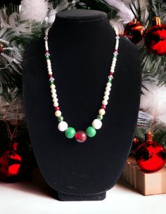 Like to dress formally for the holiday season?  Why not go for this stunning 24-inch-long necklace made with red, green, and white pearl and glass beads for a sophisticated look this Christmas!   The necklace is strung on 18-inch wire, secured with bead crimp beads, bead cover tips and connected to 4-inch linked chain and secured with a lobster claw clasp and 6mm jump ring for easy opening and closing. Caution: avoid banging or dropping necklace on hard surfaces as beads are heavy and will break! Christmas Necklaces With Colorful Beads, Christmas Necklaces With Colorful Round Beads, Christmas Necklace With Colorful Round Beads, Christmas Holiday Necklace With Round Beads, Elegant Beaded Necklace For Holiday, Elegant Beaded Christmas Necklaces, Elegant Christmas Beaded Necklaces, White Necklace For Christmas Holiday, Elegant White Christmas Necklaces