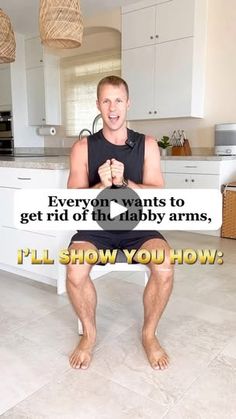 a man sitting on top of a kitchen counter holding a sign that says everyone wants to get rid of the baby arms, i'll'll show you how