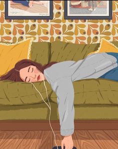 a woman laying on top of a couch with headphones