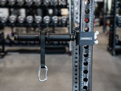 the gym equipment is neatly organized and ready to be used for strength training, including pull ups