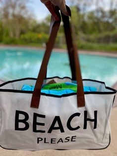 The perfect accompaniment to your trips to the shore, the lake or a weekend getaway - this "BEACH PLEASE" large canvas tote bag! It's perfect for carrying your seashells, beach reads, and other beach necessities. It's lightweight, durable, and stylish - you'll be prepared for any adventure! So grab your shades and your bag- BEACH PLEASE! Made of canvas and brown vegan leather 20" wide 11" tall 5" deep Beach Reads, Beach Necessities, Beach Please, Beach Reading, Weekend Getaway, Large Canvas, Canvas Tote Bag, Weekend Getaways, You Bag