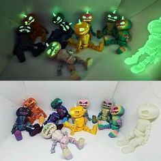 there are many different toy figures on the table and one is glowing in the dark