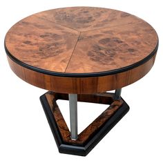 a round wooden table with metal legs