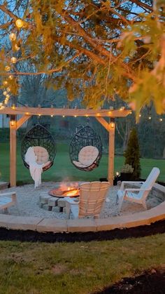 a fire pit surrounded by chairs and lights