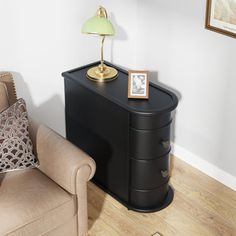 a living room with a couch, chair and lamp on the side table in front of it