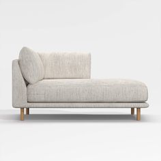 a white couch sitting on top of a wooden frame