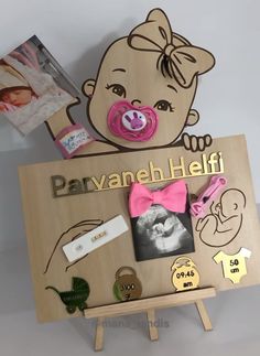 a baby's photo frame with a dummy, pacifier and other items on it