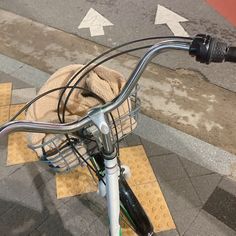 a close up of a bicycle handlebar with a basket on the front and side