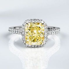 a fancy yellow diamond ring with diamonds around it