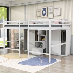 a white loft bed sitting on top of a hard wood floor next to a window