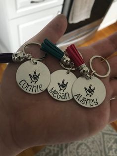 three hand stamped keychains with the words connie meagan avery on them