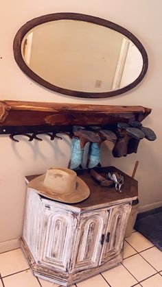 a hat is sitting on top of an old cabinet in the corner of a room