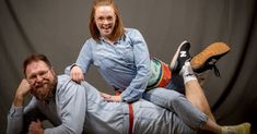 a man and woman are posing for the camera with their legs on each other's shoulders