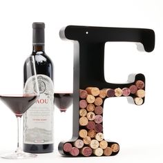 the letter f is made out of wine corks next to a bottle of wine