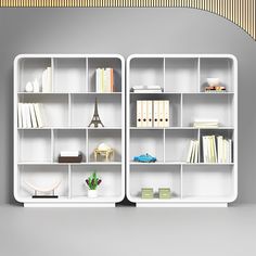 two white shelves with books and other items on them