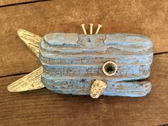 a small wooden fish with an eye on it's side