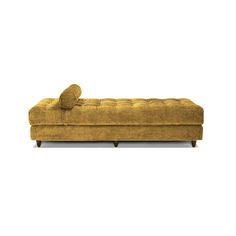 a yellow couch sitting on top of a white floor