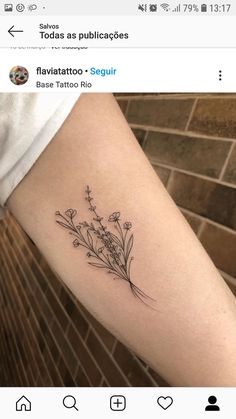 a small flower tattoo on the arm