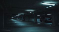 an empty parking garage at night with no one in the car park or onlookers