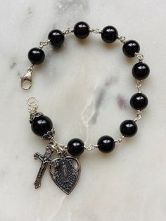 Beautiful handmade 8mm black onyx rosary bracelet.  The beads are wire-wrapped with sterling silver, 22 gauge wire and all other metal parts and medals are sterling silver. Black Bracelet, Rosary Bracelet, Jewelry Accessories Ideas, Jewelry Making Project, Dope Jewelry, Funky Jewelry, Handmade Wire, Handmade Bracelet, Jewelry Inspo