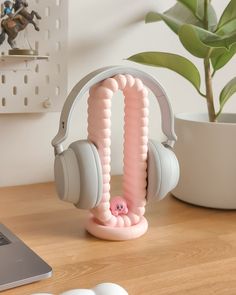 a pair of headphones sitting on top of a desk next to a laptop computer